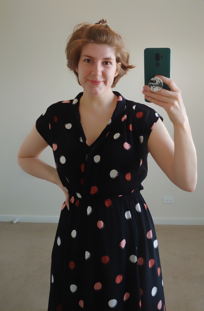 Upper-body photo of Helen in polka dot dress with folded collar.