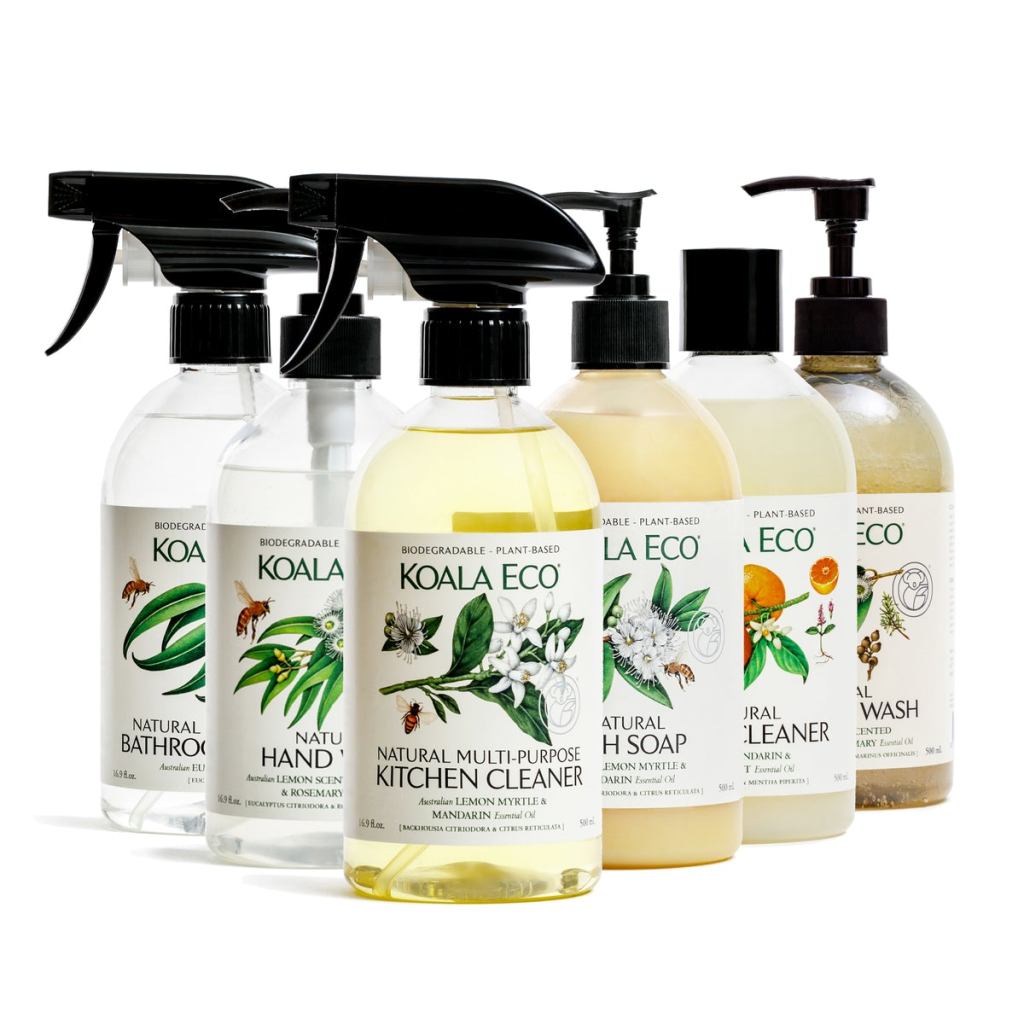 A selection of six bottles with pretty botanical drawings on the labels, each full of a different cleaning product, some with spray tops, some with standard lids, and some with pump lids.